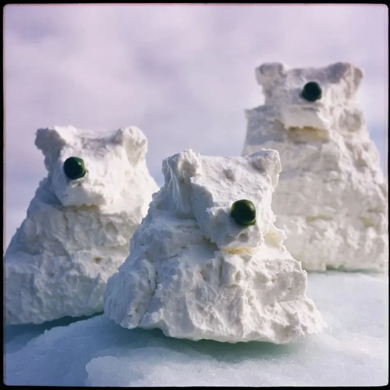 Polar Bear navigating through iceberg stacks in a frozen landscape.