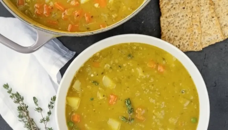 Bowl of comforting classic split pea soup topped with fresh herbs