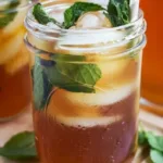Glass of honey mint iced tea garnished with fresh mint leaves